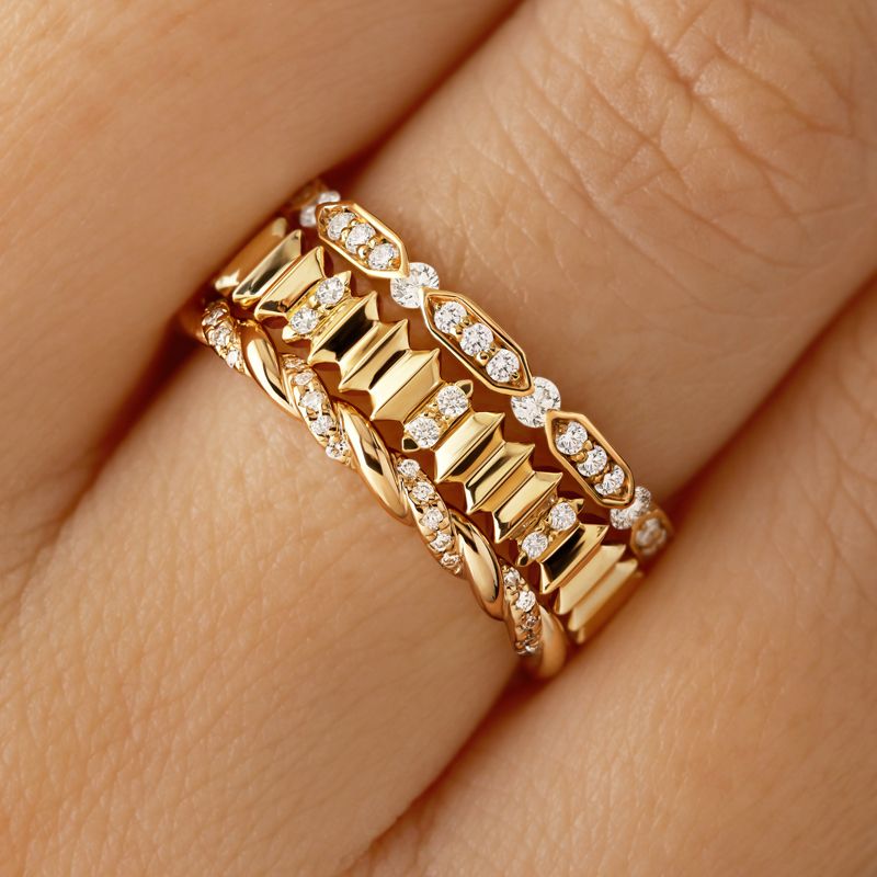 Entaille S pavée rings in 750 thousandths yellow gold and diamonds, Capucine Pavée ring in 750 thousandths pink gold and diamonds and Met M in 750 thousandths pink gold and diamonds.